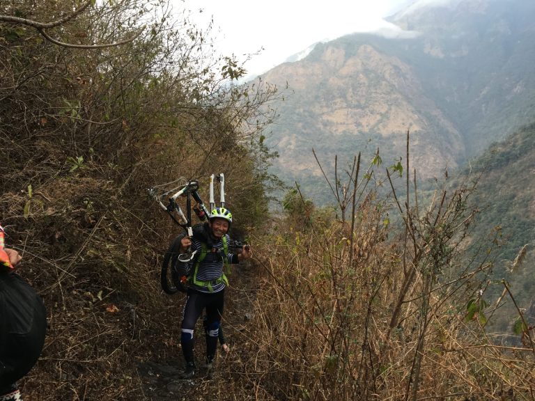 Yonten in thick of action - carrying his bike 