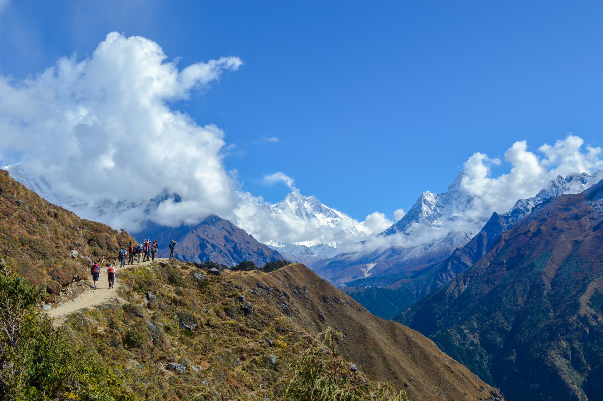 D3.14 A view at Shyangboche trekkers walking on the road and on the front having view of the mountain Range including Mt. Everest and Aamadeblam Windhorse Tours